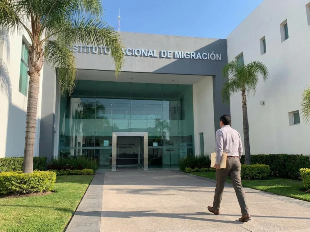 Exterior de oficina del INM Querétaro con persona llegando para trámite migratorio